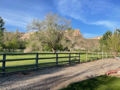 Nestled under the Colorado National Monument, with on Tiara Rado Golf Course in Colorado - for sale on GolfHomes.com, golf home, golf lot