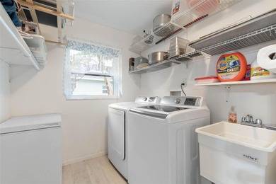 This home is located on the 5th hole of Pine Lakes Golf Course on The Grand Club - Pine Lakes Course in Florida - for sale on GolfHomes.com, golf home, golf lot