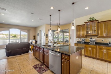 Experience lakeside living in this magnificent lakefront home in on Venetian Bay Golf Course in Florida - for sale on GolfHomes.com, golf home, golf lot