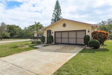 Located in the heart of Palm Harbor, 102 Stanford Drive is on Highland Lakes Executive Golf Course in Florida - for sale on GolfHomes.com, golf home, golf lot