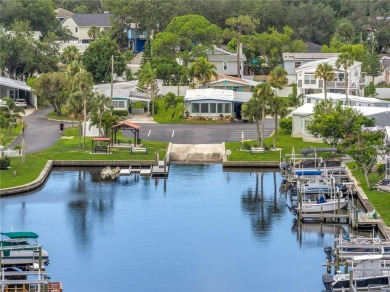 WATERFRONT LIVING | Fully Furnished | 2021 Palm Harbor Home
 on Mangrove Bay Golf Course in Florida - for sale on GolfHomes.com, golf home, golf lot