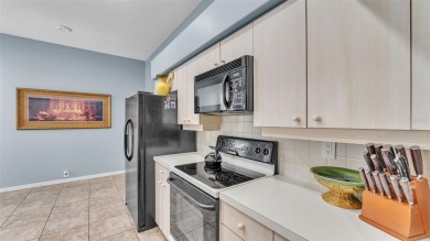 Enjoy peaceful golf course and water views from this 2-bedroom on Imperial Lakes Country Club in Florida - for sale on GolfHomes.com, golf home, golf lot