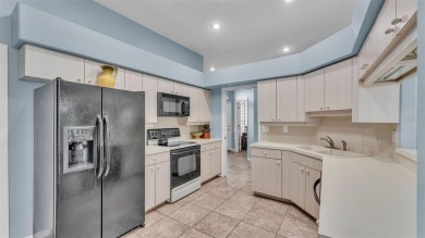 Enjoy peaceful golf course and water views from this 2-bedroom on Imperial Lakes Country Club in Florida - for sale on GolfHomes.com, golf home, golf lot