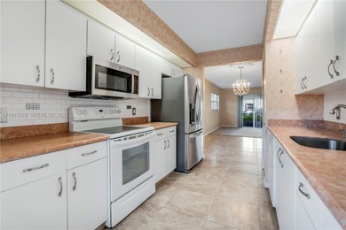 Ground floor corner Magnolia unit, with garden views, and on Flamingo Lakes Country Club in Florida - for sale on GolfHomes.com, golf home, golf lot