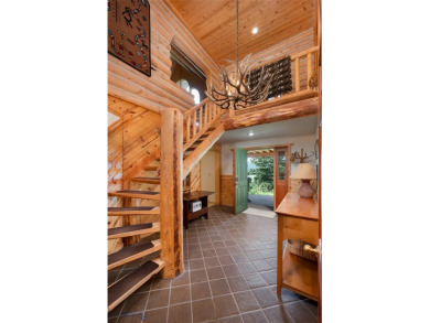 This charming log home, nestled in the trees and perched above on Big Sky of Montana Golf Course in Montana - for sale on GolfHomes.com, golf home, golf lot