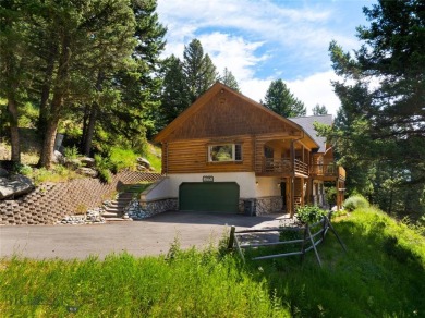 This charming log home, nestled in the trees and perched above on Big Sky of Montana Golf Course in Montana - for sale on GolfHomes.com, golf home, golf lot