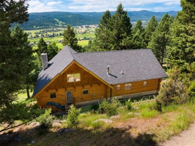 This charming log home, nestled in the trees and perched above on Big Sky of Montana Golf Course in Montana - for sale on GolfHomes.com, golf home, golf lot