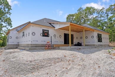 Tucked inside a gated golf community, this newly constructed on Ledgestone Country Club and Golf Course in Missouri - for sale on GolfHomes.com, golf home, golf lot