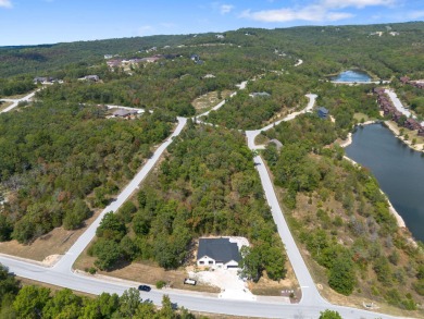 Tucked inside a gated golf community, this newly constructed on Ledgestone Country Club and Golf Course in Missouri - for sale on GolfHomes.com, golf home, golf lot