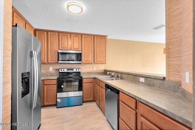 This condo features two bedrooms each with their own private on Golf Club At Fleming Island in Florida - for sale on GolfHomes.com, golf home, golf lot