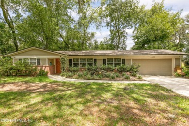 Nestled within a canopy of lush trees, this charming 1960s home on Blue Cypress Golf Club in Florida - for sale on GolfHomes.com, golf home, golf lot