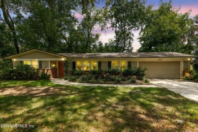 Nestled within a canopy of lush trees, this charming 1960s home on Blue Cypress Golf Club in Florida - for sale on GolfHomes.com, golf home, golf lot