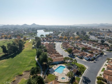 This darling home adorns a winding street in the tightly-knit on Menifee Lakes Country Club - Lakes in California - for sale on GolfHomes.com, golf home, golf lot