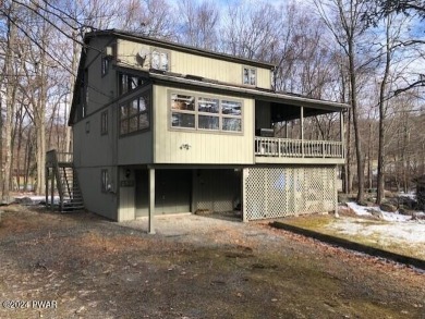 Bordering the 13th fairway, this Tanglwood Lakes homes offers 3 on Paupack Hills Golf and Country Club in Pennsylvania - for sale on GolfHomes.com, golf home, golf lot