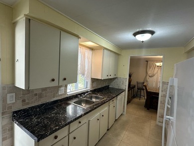 Rarely available lakefront 2BR/2BA double-wide coach home in on Boca Grove Golf and Tennis in Florida - for sale on GolfHomes.com, golf home, golf lot