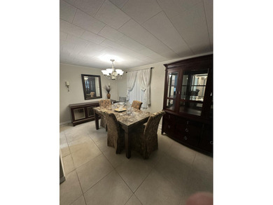 Rarely available lakefront 2BR/2BA double-wide coach home in on Boca Grove Golf and Tennis in Florida - for sale on GolfHomes.com, golf home, golf lot