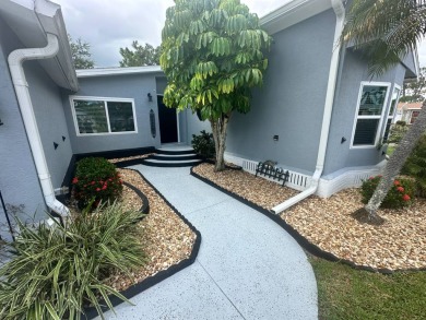 This completely remodeled, stucco Palm Harbor home is located on on Del Tura Golf and Country Club in Florida - for sale on GolfHomes.com, golf home, golf lot