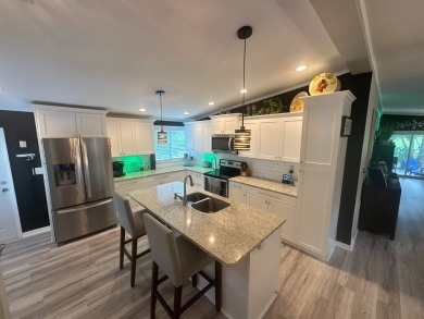 This completely remodeled, stucco Palm Harbor home is located on on Del Tura Golf and Country Club in Florida - for sale on GolfHomes.com, golf home, golf lot