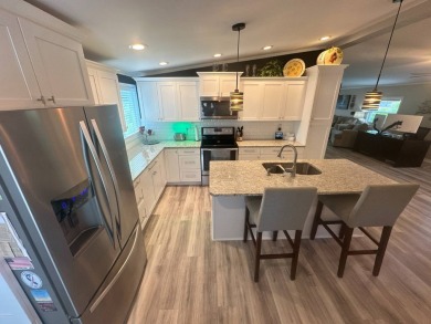 This completely remodeled, stucco Palm Harbor home is located on on Del Tura Golf and Country Club in Florida - for sale on GolfHomes.com, golf home, golf lot