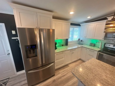 This completely remodeled, stucco Palm Harbor home is located on on Del Tura Golf and Country Club in Florida - for sale on GolfHomes.com, golf home, golf lot