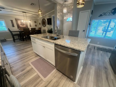 This completely remodeled, stucco Palm Harbor home is located on on Del Tura Golf and Country Club in Florida - for sale on GolfHomes.com, golf home, golf lot