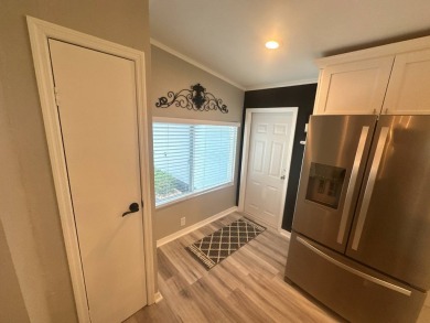 This completely remodeled, stucco Palm Harbor home is located on on Del Tura Golf and Country Club in Florida - for sale on GolfHomes.com, golf home, golf lot