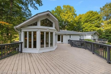 Tucked away on a wooded lot that directly backs up to McClumpha on Hilltop Golf Course in Michigan - for sale on GolfHomes.com, golf home, golf lot
