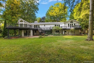 Tucked away on a wooded lot that directly backs up to McClumpha on Hilltop Golf Course in Michigan - for sale on GolfHomes.com, golf home, golf lot