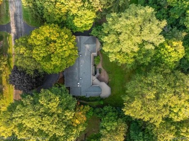Tucked away on a wooded lot that directly backs up to McClumpha on Hilltop Golf Course in Michigan - for sale on GolfHomes.com, golf home, golf lot