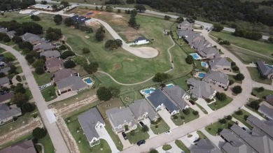 Elegant residence located at the first hole of the golf course on The Golf Club at Resort Eagle Mountain Lake in Texas - for sale on GolfHomes.com, golf home, golf lot