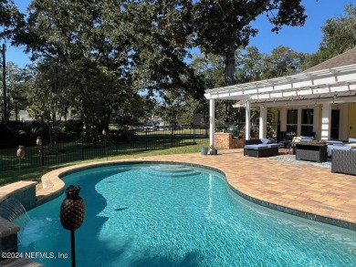 Discover your dream home in the exclusive Queens Harbour Yacht & on Queens Harbour Yacht and Country Club in Florida - for sale on GolfHomes.com, golf home, golf lot