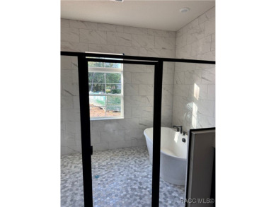 This meticulously crafted 2025 Genesis 2 model home boasts 3 on Southern Woods Golf Club in Florida - for sale on GolfHomes.com, golf home, golf lot