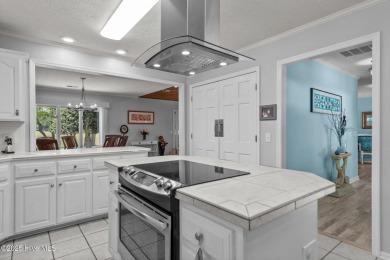 Spacious Coastal Retreat with Sunroom & Outdoor Entertaining on Brick Landing Plantation Yacht and Golf Club in North Carolina - for sale on GolfHomes.com, golf home, golf lot