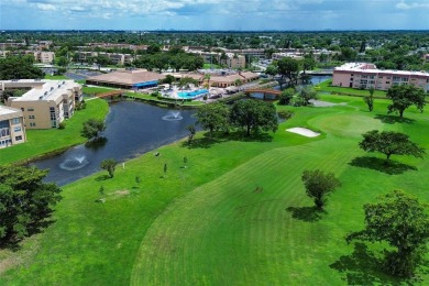 Wake up to tranquil water views in this stunning 2-bedroom on Sunrise Lakes Phase III in Florida - for sale on GolfHomes.com, golf home, golf lot