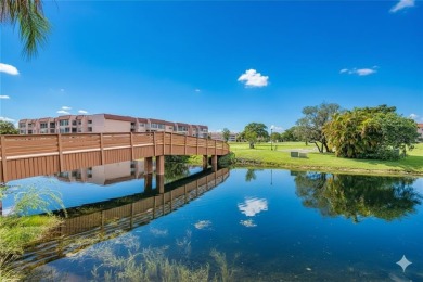 Wake up to tranquil water views in this stunning 2-bedroom on Sunrise Lakes Phase III in Florida - for sale on GolfHomes.com, golf home, golf lot