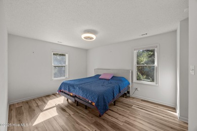 Tucked among the trees in the waterfront community of Fairfield on Harbour Point Golf Club in North Carolina - for sale on GolfHomes.com, golf home, golf lot