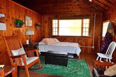 Step into rustic charm with this almost all-knotty pine interior on Birch Pointe Golf Club in Michigan - for sale on GolfHomes.com, golf home, golf lot