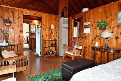 Step into rustic charm with this almost all-knotty pine interior on Birch Pointe Golf Club in Michigan - for sale on GolfHomes.com, golf home, golf lot