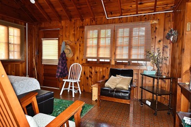 Step into rustic charm with this almost all-knotty pine interior on Birch Pointe Golf Club in Michigan - for sale on GolfHomes.com, golf home, golf lot