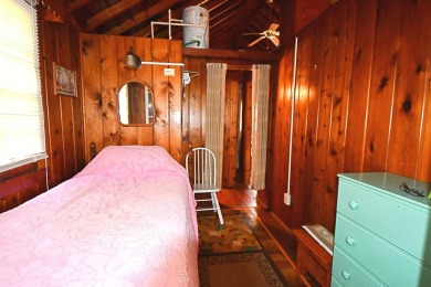 Step into rustic charm with this almost all-knotty pine interior on Birch Pointe Golf Club in Michigan - for sale on GolfHomes.com, golf home, golf lot