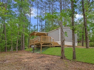 Nestled among the pines, this charming 2-bedroom, 2-bath turnkey on Rayburn Country Club in Texas - for sale on GolfHomes.com, golf home, golf lot
