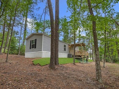 Nestled among the pines, this charming 2-bedroom, 2-bath turnkey on Rayburn Country Club in Texas - for sale on GolfHomes.com, golf home, golf lot
