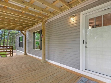 Nestled among the pines, this charming 2-bedroom, 2-bath turnkey on Rayburn Country Club in Texas - for sale on GolfHomes.com, golf home, golf lot