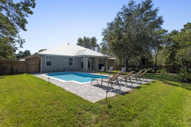Nestled on an oversized lot, this single-level brick home in on Santa Rosa Golf and Beach Club in Florida - for sale on GolfHomes.com, golf home, golf lot