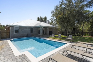 Nestled on an oversized lot, this single-level brick home in on Santa Rosa Golf and Beach Club in Florida - for sale on GolfHomes.com, golf home, golf lot