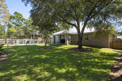 Nestled on an oversized lot, this single-level brick home in on Santa Rosa Golf and Beach Club in Florida - for sale on GolfHomes.com, golf home, golf lot