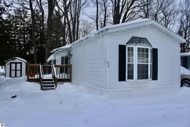 This beautifully maintained and updated home has 400 ft of on Elk Rapids Golf Club in Michigan - for sale on GolfHomes.com, golf home, golf lot