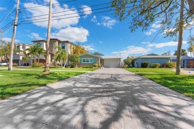 Discover unparalleled waterfront living with expansive views of on Mangrove Bay Golf Course in Florida - for sale on GolfHomes.com, golf home, golf lot