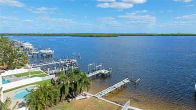 Discover unparalleled waterfront living with expansive views of on Mangrove Bay Golf Course in Florida - for sale on GolfHomes.com, golf home, golf lot