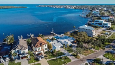 Discover unparalleled waterfront living with expansive views of on Mangrove Bay Golf Course in Florida - for sale on GolfHomes.com, golf home, golf lot